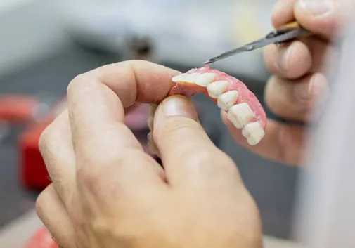 Working on fixed denture in lab